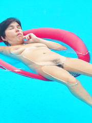 Wife naked in the pool floating on a red float