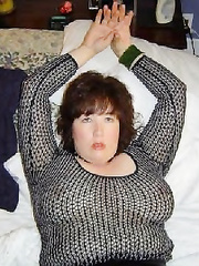 chubby slut wearing leather skirt and fishnet top