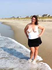 Showing off boobs on public beach while on vacation