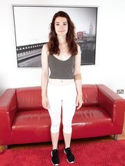 legal age teenager Flora slides her yoga pant down to flash her shaggy pussy