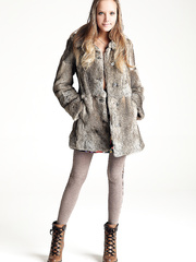 Wonderful legal age teenager beauty takes off her fur coat and leggings to model undressed in boots