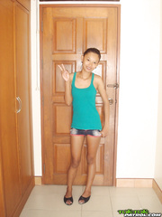 Fragile Thai angel takes her pants off and stays nude in doorway