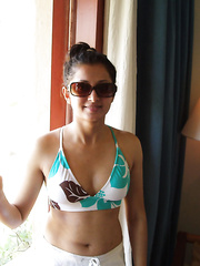 Indian female is caught in her underclothing during the time that trying on different outfits