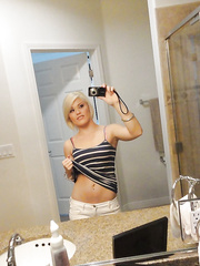 Juvenile blond honey Ash Hollywood taking selfies in mirror during the time that undressing