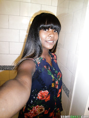 Playful ebon playgirl revealing her goods and making selfies