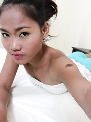 Small Oriental dilettante teases on sofa with her constricted legal age teenager love tunnel on display