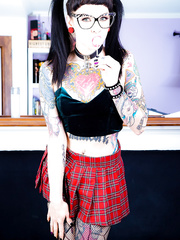 Tattooed Necro Nicki in pigtails & short petticoat on knees showing constricted booty