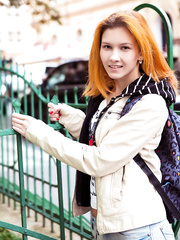 Youthful redhead takes off her clothing to proudly display her shaved snatch