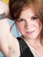 Lascivious redhead Zia discloses her shaggy body during the time that posing at home