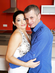 Aged brunette hair and her paramour warm up with foreplay in the kitchen