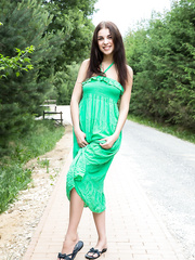 Wicked dark brown Evita Lima flashes a bare upskirt then disrobes in the roadway