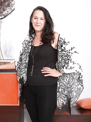 Over-thirty lady with darksome hair proudly displays her beaver after stripping in nature's garb