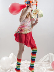 Slim legal age teenager hotty in pigtails and multi-colored socks takes off her raiment