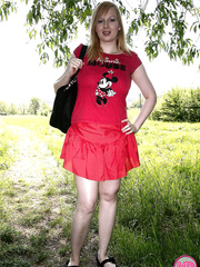 Breasty blond cutie exposes her giant juggs and toys with marital-device below a tree