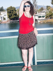 Overweight dark brown Tamar undresses in nature's garb on a balcony overlooking a river