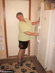 Old woman Girdle Headmistress disrobes to hose in her kitchen