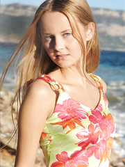 Enchanting juvenile thing plays undressed on the rocks baring her tiny milk cans on the beach