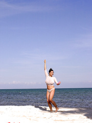 Super breasty Chloe Vevrier letting her huge large breasts hang loose at the beach