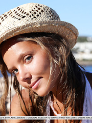 Youn gteen Mango A on beach showing off small mounds and shaved cunt close up