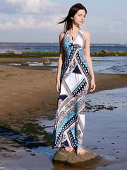 Dark Brown teenager Sasha Rose slides off her costume to pose naked at water's edge