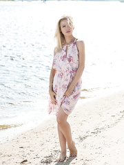 Blond solo model slides off her suit and pants at the beach