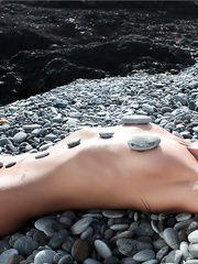 Zooty female nudist exposing her spectacular body by the water