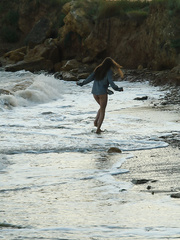 Worthy legal age teenager angel Petra E removes her shirt after wading out into the ocean