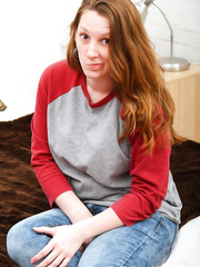 Natural redhead Amber removes her jeans and brassiere to pose with undressed large pantoons