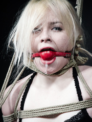 Fair skinned female is left out in the ice and snow after being hogtied