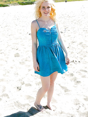 Playful golden-haired sweetie acquires rid of her costume and bikini top on the beach