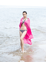 Youthful Mary pulls aside her bikini bottom to flash hairless beaver at the beach