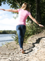 Blond non-professional exposes her lace underclothing during waterside walk in blue jeans