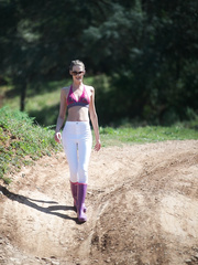 Thin solo model Melissa Tongue disrobes to her rubber boots in stream