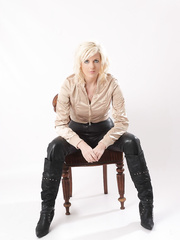 Golden-Haired babe in leather panties and boots lets her wobblers loose from silk blouse