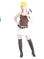 Blond babe Axa positions in leather boots and hard hat whilst flashing scoops