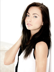 Erotic model disrobes off to lift her legs & pose in naked feet in the kitchen