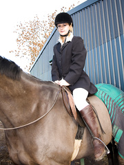 Hot equestrian Laurita undresses riding garments in the tack room to widen a-hole