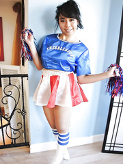 Diminutive Asian cheerleader May Lee flashing dark pants below petticoat