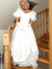 Recent bride clothed in her wedding costume plays water sport games at reception