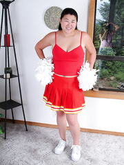 Plump Oriental 1st timer baring miniature milk shakes whilst shedding cheer uniform