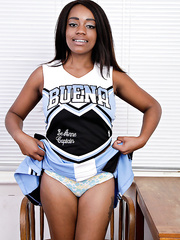 Dark non-professional removes her cheerleader uniform to model in the bare