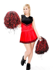 Blond cheerleader puts down her pom poms and takes off her raiment