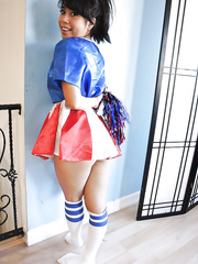 Petite Oriental cheerleader May Lee posing in cute uniform and socks