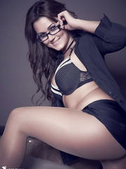 Glamour model Kat Dee blows a kiss wearing hose and glasses