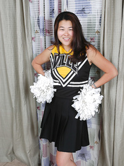 Dilettante Oriental cheerleader disrobes to disclose trimmed cum-hole