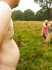 Nasty golden-haired women tie up a  and jerk him off in a field