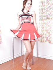 Youthful Oriental non-professional Mila Jade exposing petite milk cans below cheerleader outfit