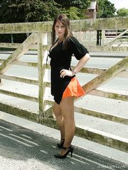 Nice-Looking dark brown climbs a fence to model non naked her nice-looking legs in heels