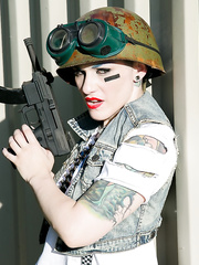 Tattooed hottie with bald head in army gear giving stud in ape mask a BJ