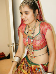 Erotic juvenile Indian removes ethnic clothes to pose topless in cotton pants